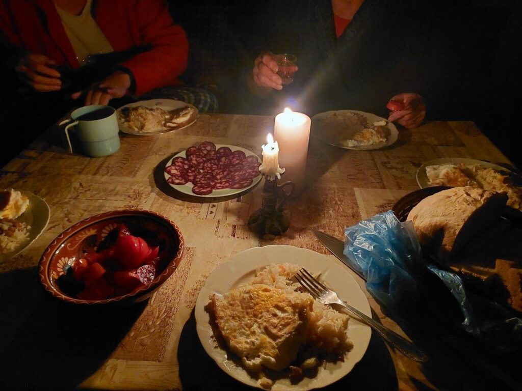 Oleksandr's family having dinner by candlelight during the Russian invasion of Ukraine.